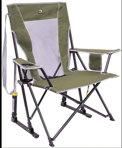 An outdoor folding camp chair with an olive green fabric body, a light gray mesh backrest insert, and a black metal frame. It features a side pocket on the armrest holding a smartphone, a cup holder, and a small side pouch.